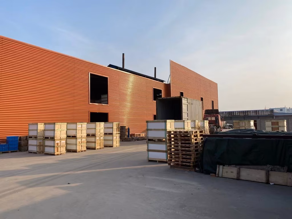 The Taizhou works at golden hour, finished panels crated for shipment