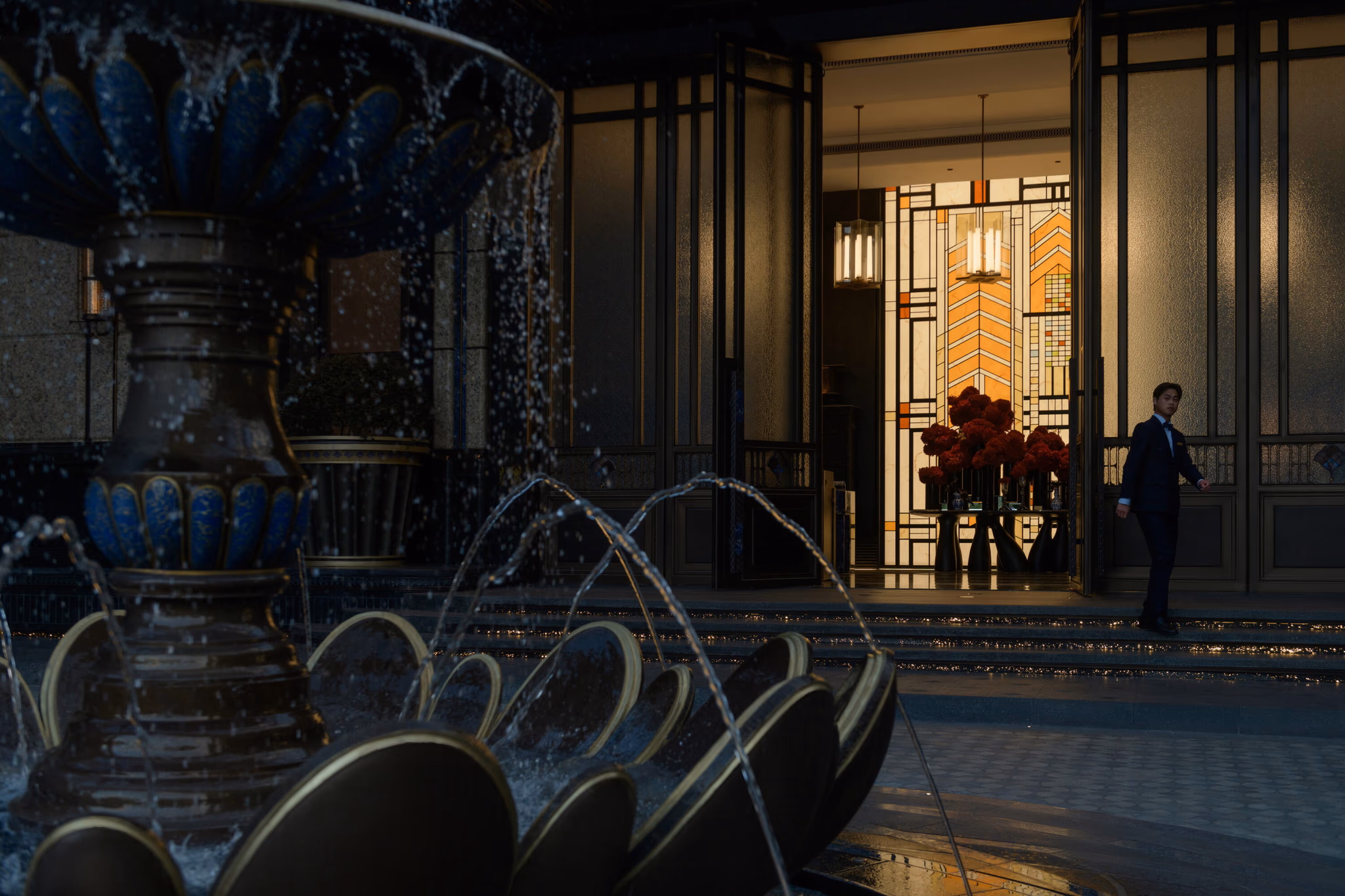 Shanghai Jianfa Haiyue entrance at dusk — the stained-glass screen lit from within